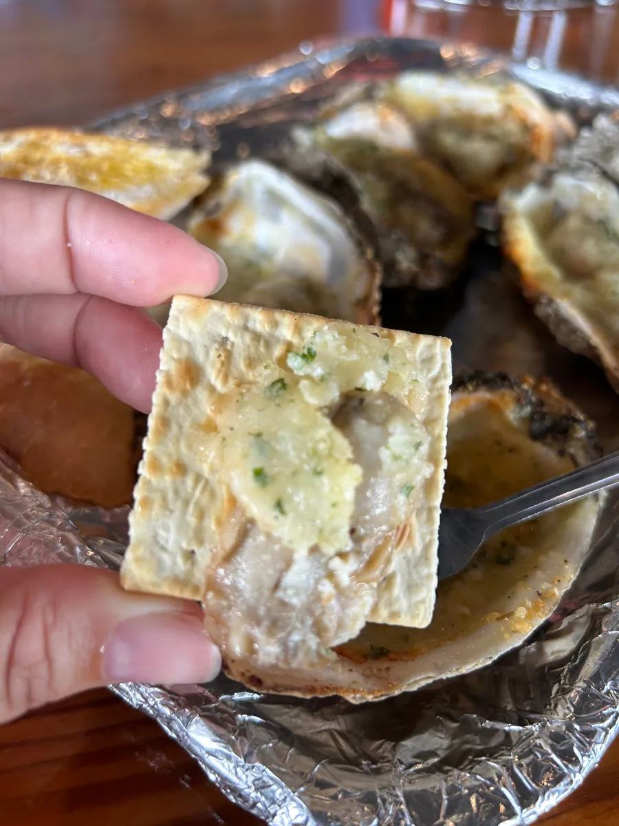 Garlic baked oyster served with a cracker at Hunt's Oyster Bar in Panama City, Florida.