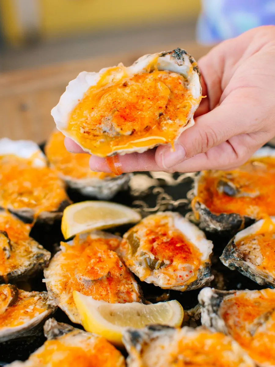 Baked oysters topped with melted cheese served at Hunt's Oyster Bar in Panama City, Florida.