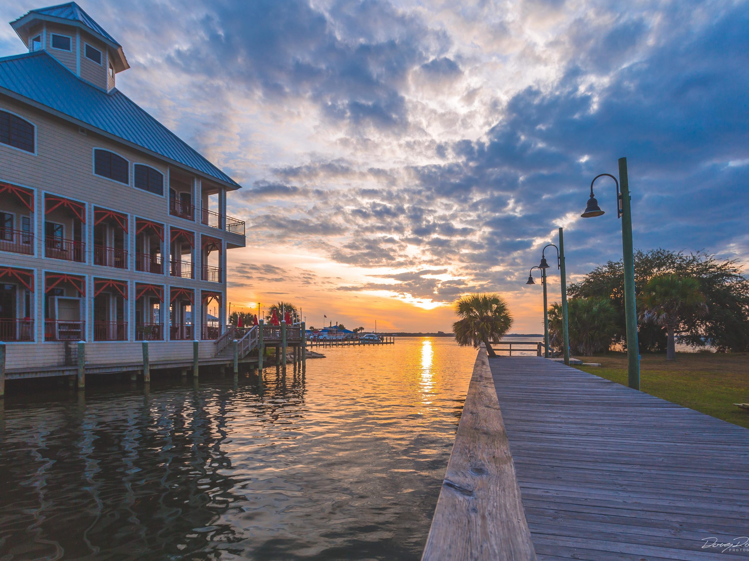 Sunset view of the boardwalk at CSS Yacht Basin in Historic St. Andrews, a serene and relaxing spot in Panama City.