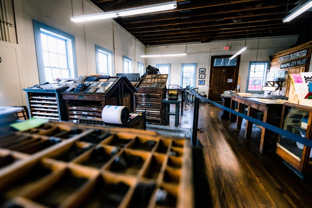 Interior view of the Panama City Publishing Company Museum showing vintage printing equipment and historic newspaper displays, highlighting one of the top museums in Panama City.