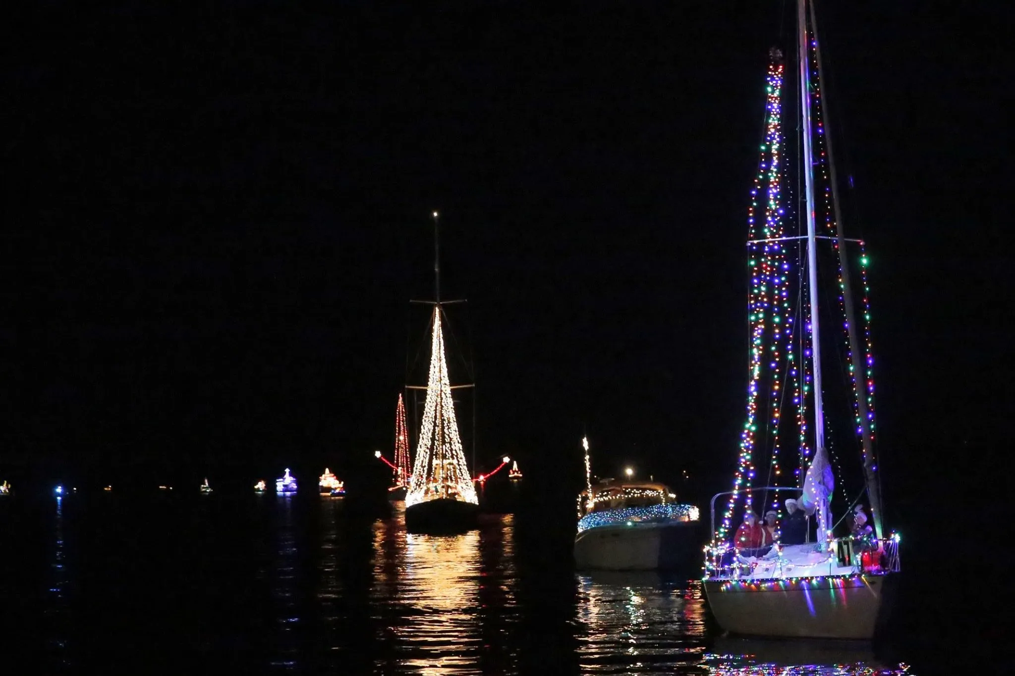 Decorated boats cruising St. Andrews Bay during the annual Boat Parade of Lights, a favorite winter in Panama City tradition