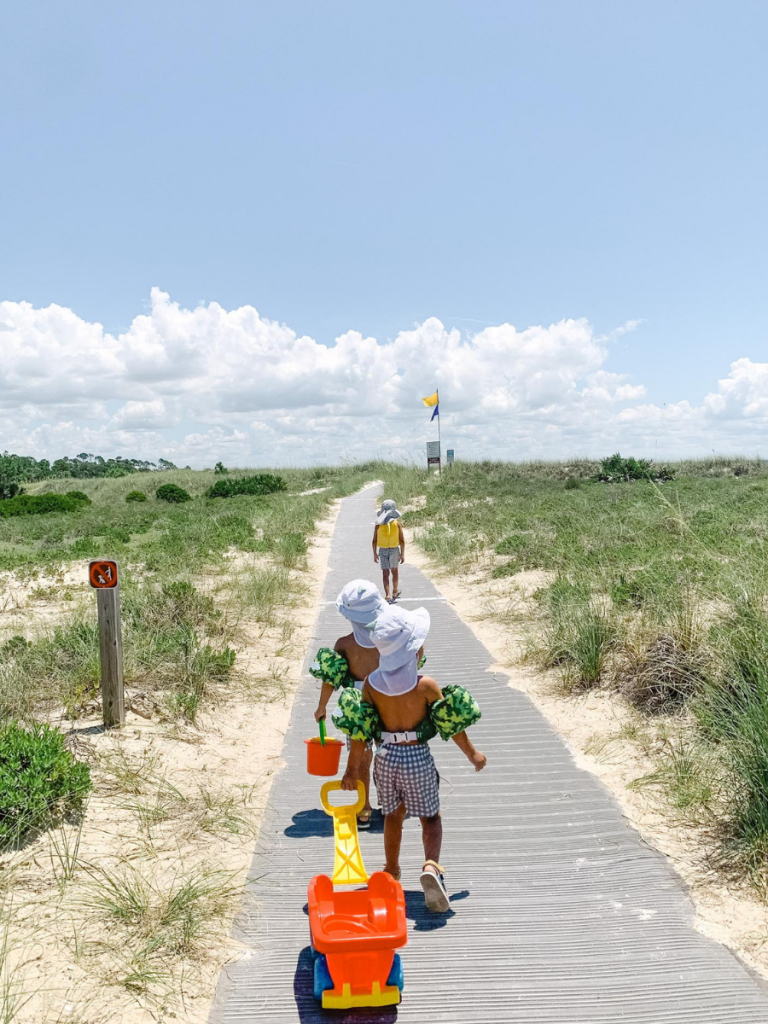 Top 10 Activities for a Family-Friendly Spring Break in Panama City, Florida 25 Children walking along a boardwalk toward the beach during a family-friendly spring break in Panama City.
