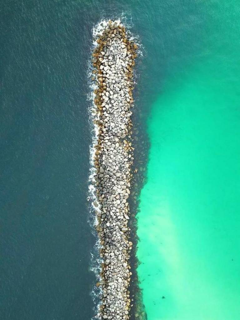 Best Diving in Florida: Planning a Dive Trip in Panama City 7 Aerial view of rock jetty dividing deep and shallow waters, popular site for diving in Florida