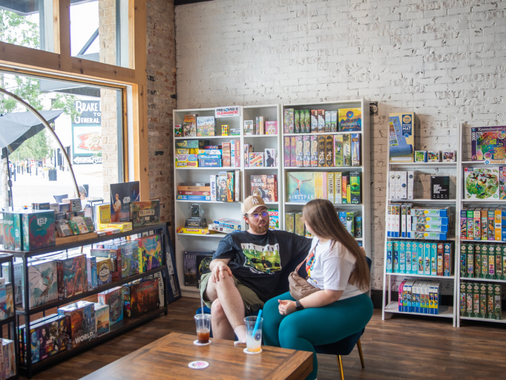 Top 10 Activities for a Family-Friendly Spring Break in Panama City, Florida 24 Couple browsing and playing board games at a tabletop game café during a family-friendly spring break in Panama City.