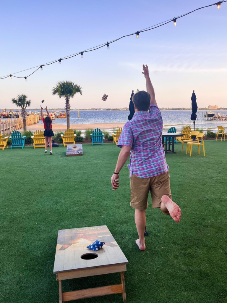 Top 10 Activities for a Family-Friendly Spring Break in Panama City, Florida 12 Family playing cornhole and yard games along the waterfront during a family-friendly spring break in Panama City.