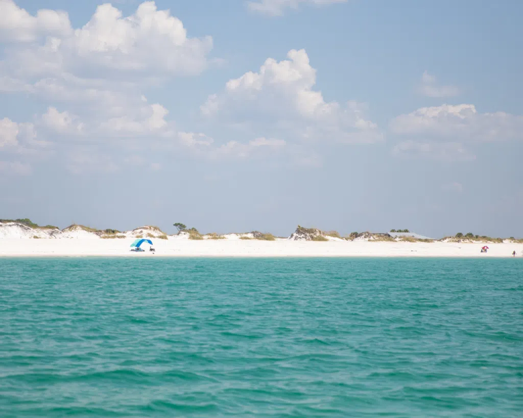 3 Fun Spots for Snorkeling in Panama City, Florida: Where to Go and What to Know 5 Scenic view of clear turquoise water and white sand at St. Andrews State Park, a popular spot for snorkeling in Panama City, Florida.