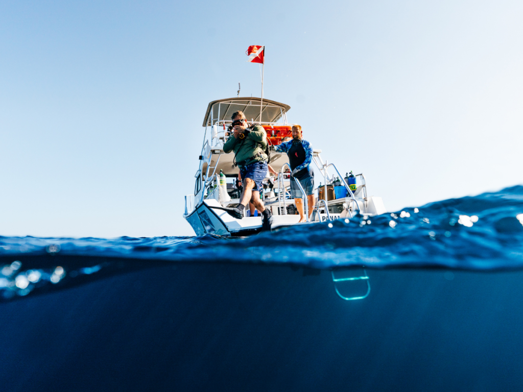 Top Spring Break Outdoor Adventures in Panama City, Florida 2 Spring break outdoor adventures in Panama City featuring scuba divers entering the water from a dive boat on the Gulf.