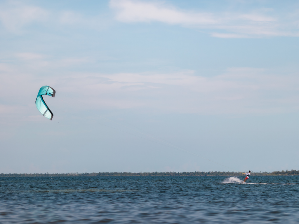 Top Spring Break Outdoor Adventures in Panama City, Florida 7 Spring break outdoor adventures in Panama City featuring a kite surfer riding across the open waters of St. Andrews Bay.