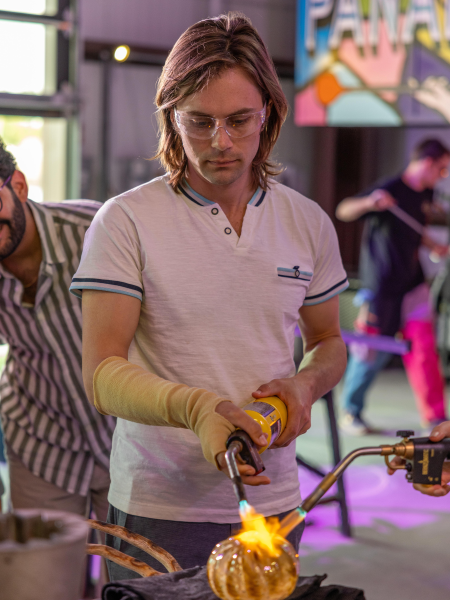 Artist shaping molten glass at Panama City Hot Glass, one of the most unique hands-on activities in Panama City Florida