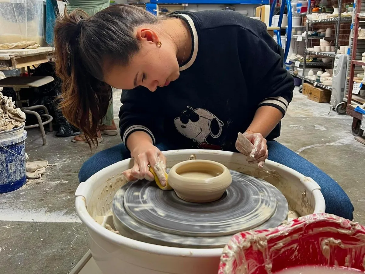 Woman throwing pottery on a wheel, one of the most popular hands-on activities in Panama City Florida