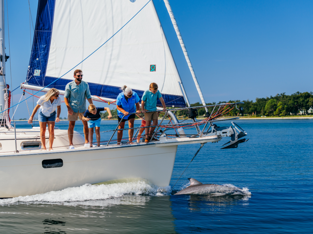 Family enjoying a sailing and dolphin experience on St. Andrews Bay, a standout skillcation activity in Florida