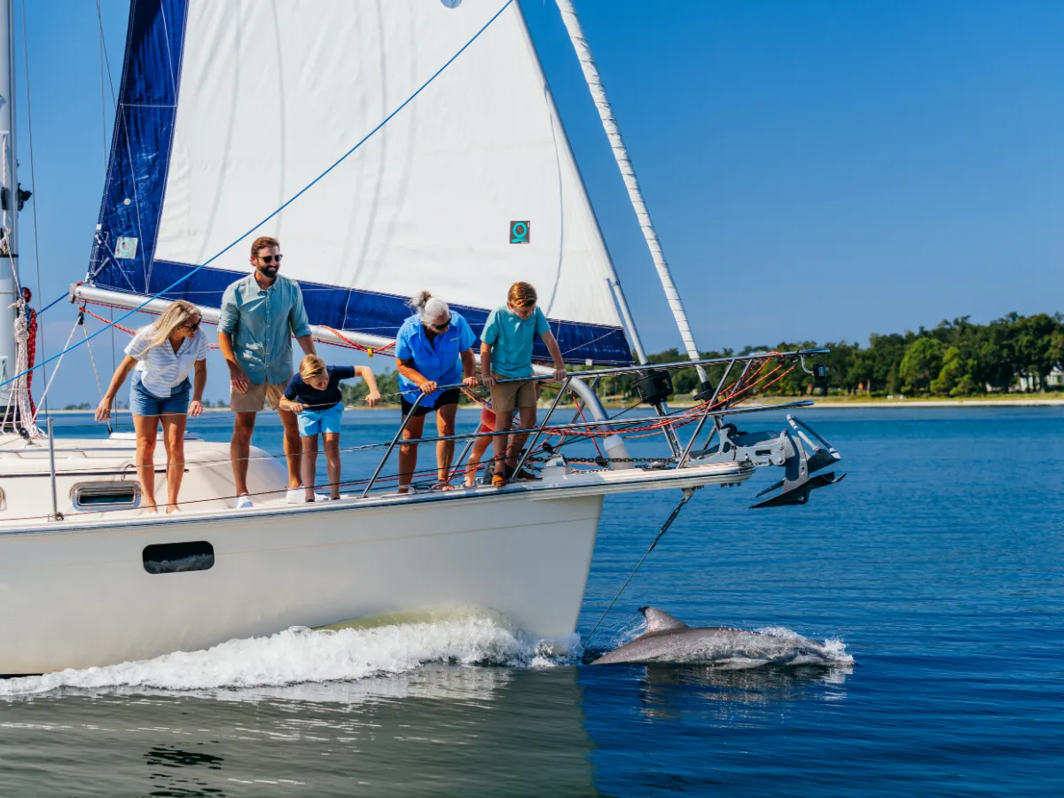 Family enjoying a sailing and dolphin experience on St. Andrews Bay, a standout skillcation activity in Florida