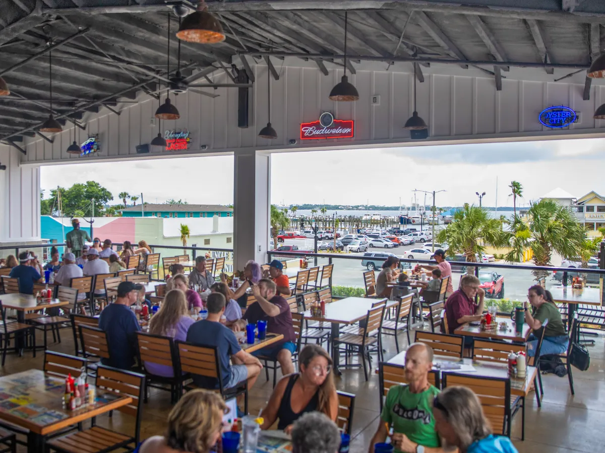Hook and Cook in Panama City, FL: Where to Bring Your Fresh Catch for Dinner 10 Open-air dining deck at Hunt's Oyster Bar overlooking the marina, a favorite spot for hook and cook in Panama City FL
