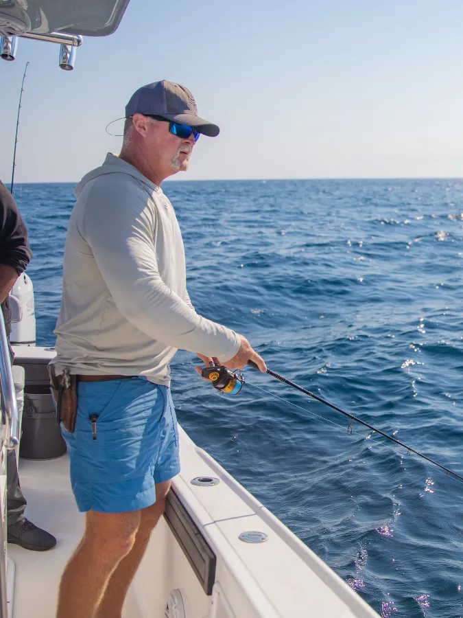 Hook and Cook in Panama City, FL: Where to Bring Your Fresh Catch for Dinner 3 Angler fishing offshore in Panama City, catching the fresh Gulf fish that makes hook and cook in Panama City FL so memorable