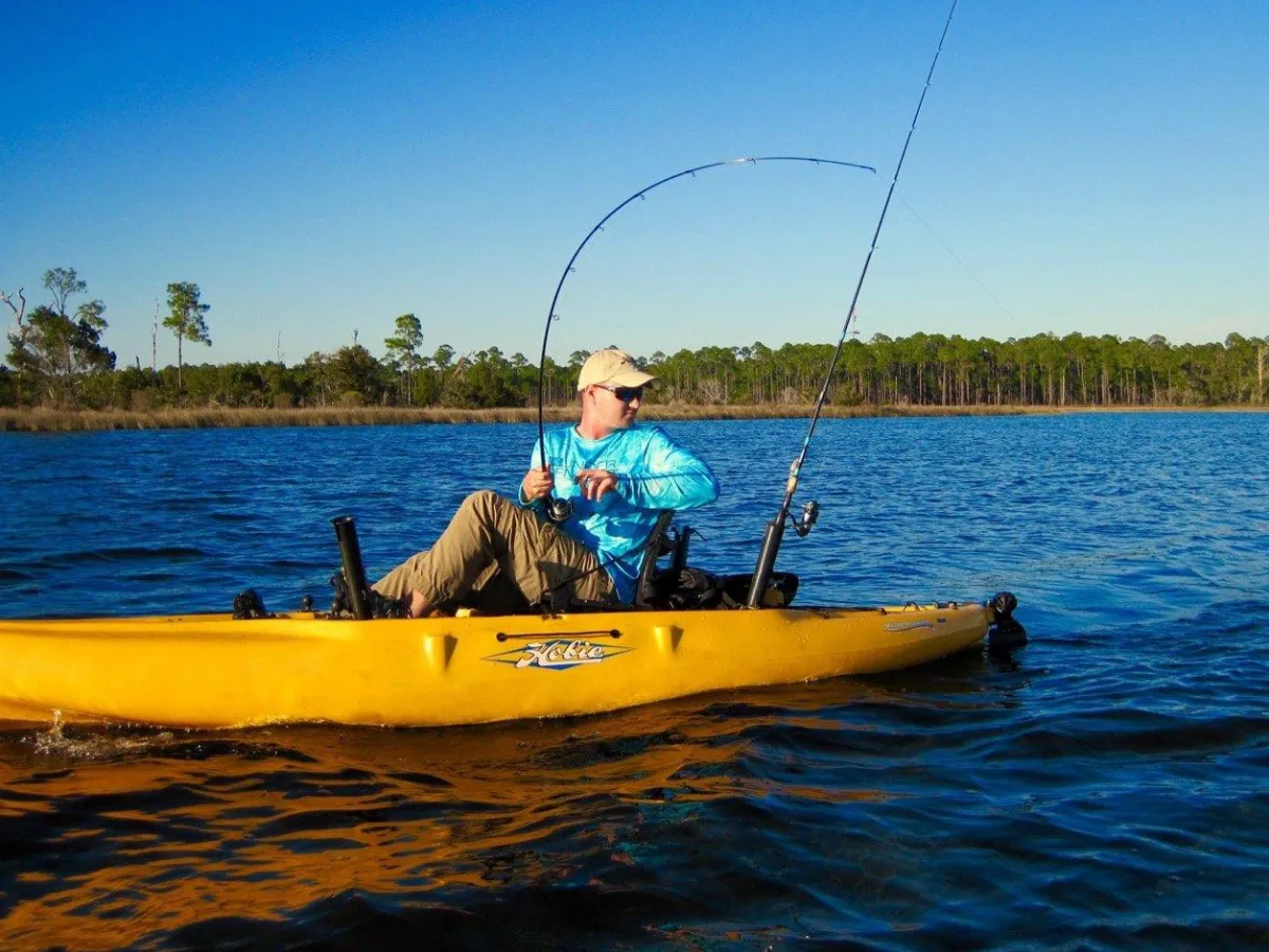 Angler fighting a fish from a kayak in the backwaters of Panama City, one of the most rewarding ways to fish in Panama City FL