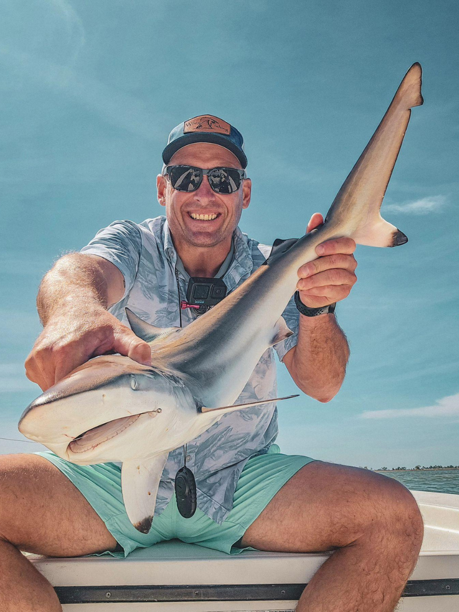 Types of Fishing in Panama City, Florida: Every Way to Get on the Water 3 Angler holding a shark caught inshore near Panama City, showcasing the variety of types of fishing in Panama City FL