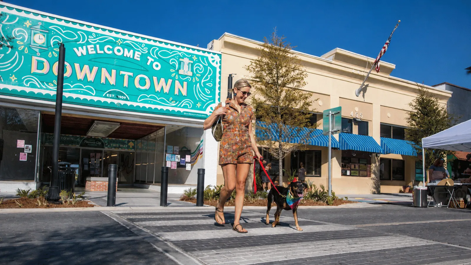 A woman walking her dog in Downtown Panama City on the arts and culture itinerary in Panama City, Florida