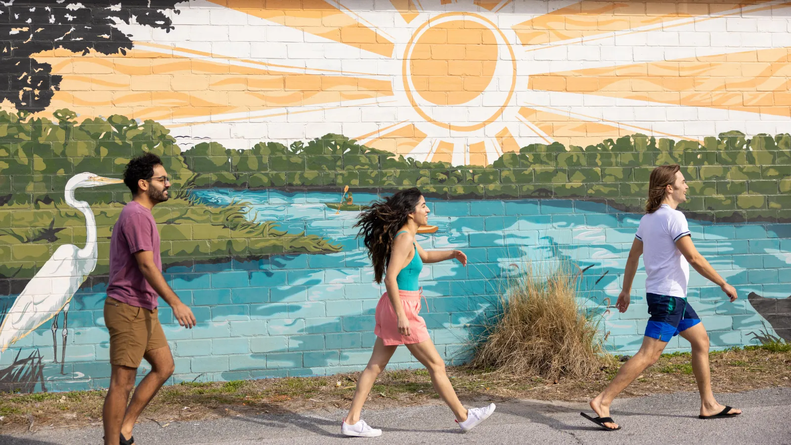 A group of friends exploring the mural trail on the arts and culture itinerary in Panama City, Florida