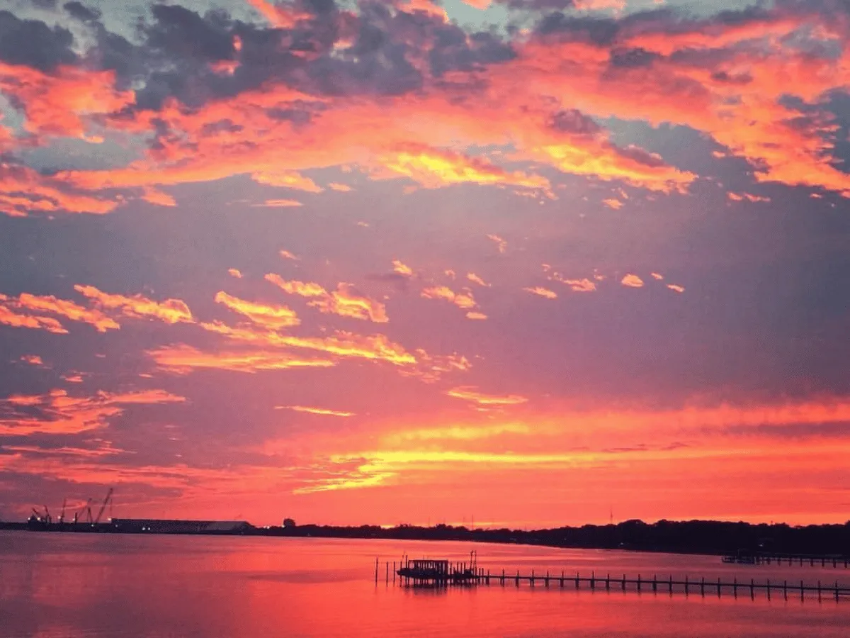 Colorful clouds reflecting across St. Andrews Bay during sunset in Panama City Florida.