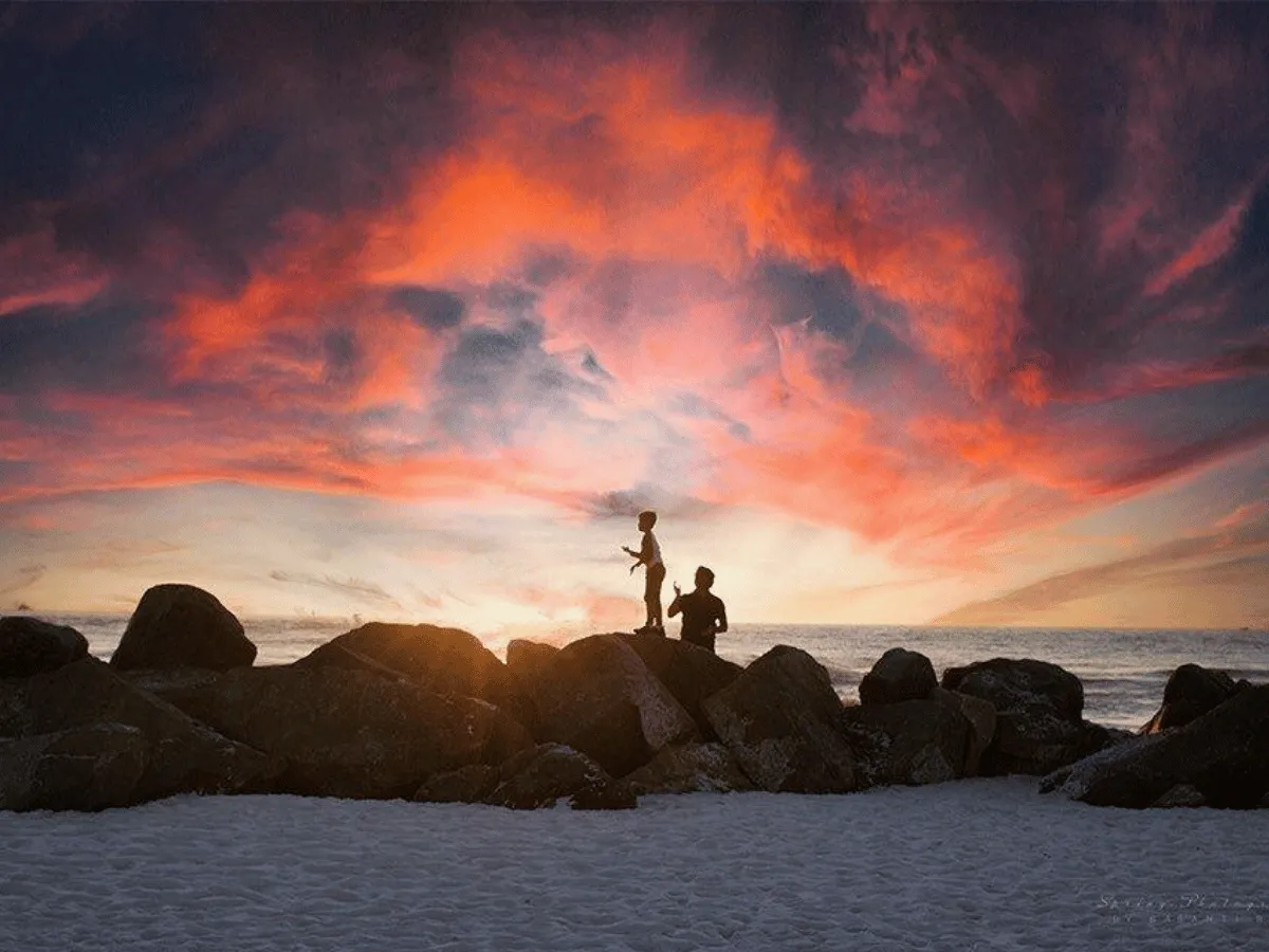 Silhouettes watching a brilliant sunset from the jetties near Panama City Florida.