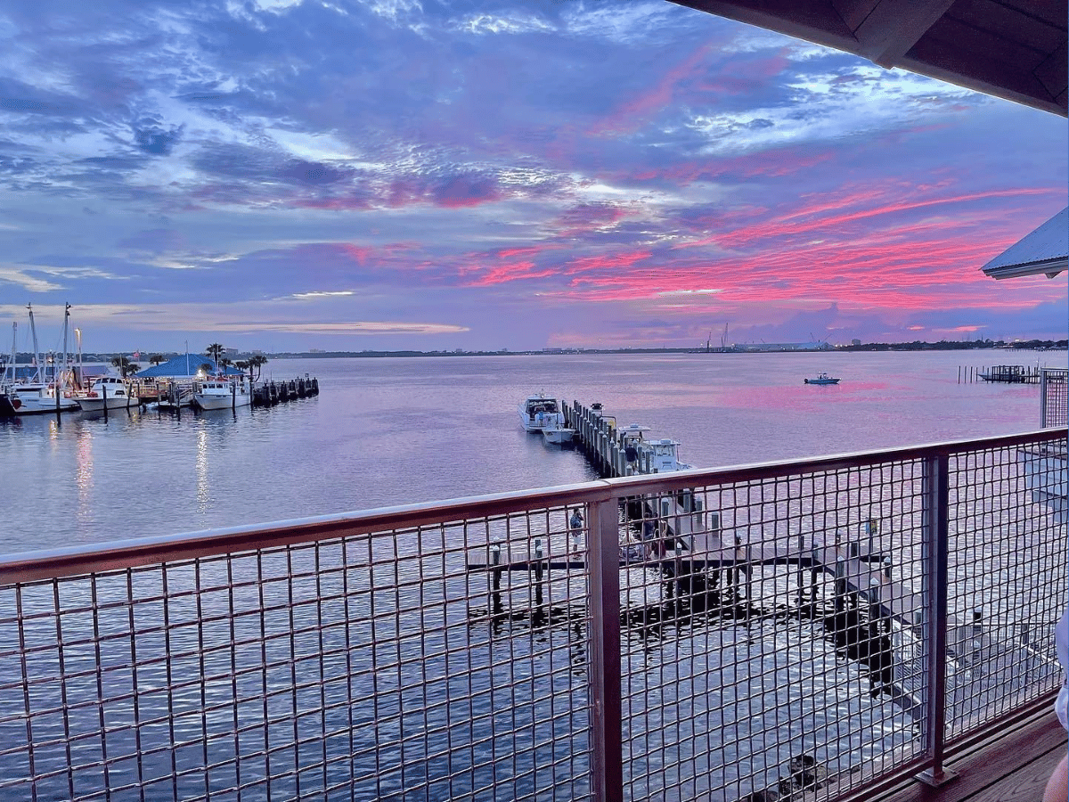 Where to Watch the Best Sunset in Panama City, Florida 13 Waterfront marina reflecting colorful evening skies at sunset in Panama City Florida.