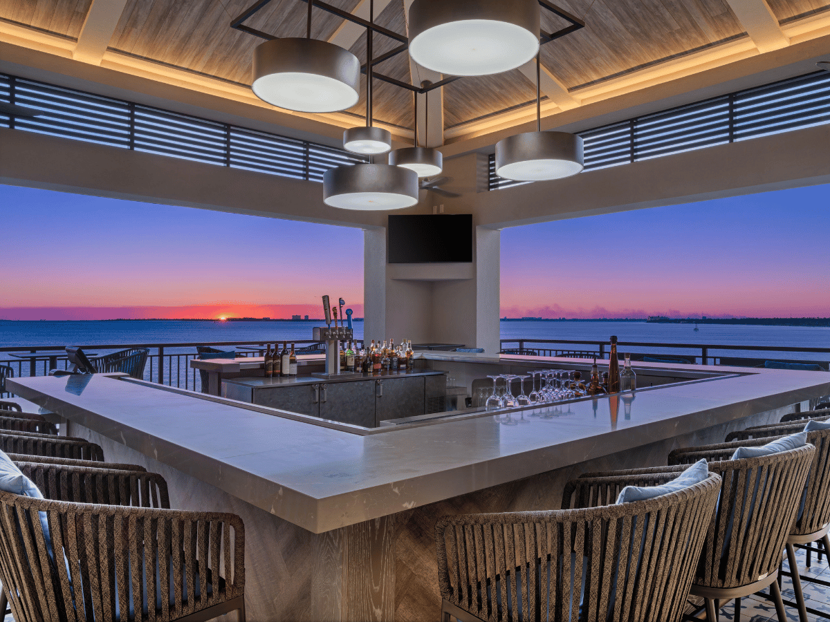 Where to Watch the Best Sunset in Panama City, Florida 12 Rooftop bar overlooking a colorful sunset in Panama City Florida at Hotel Indigo Marina.