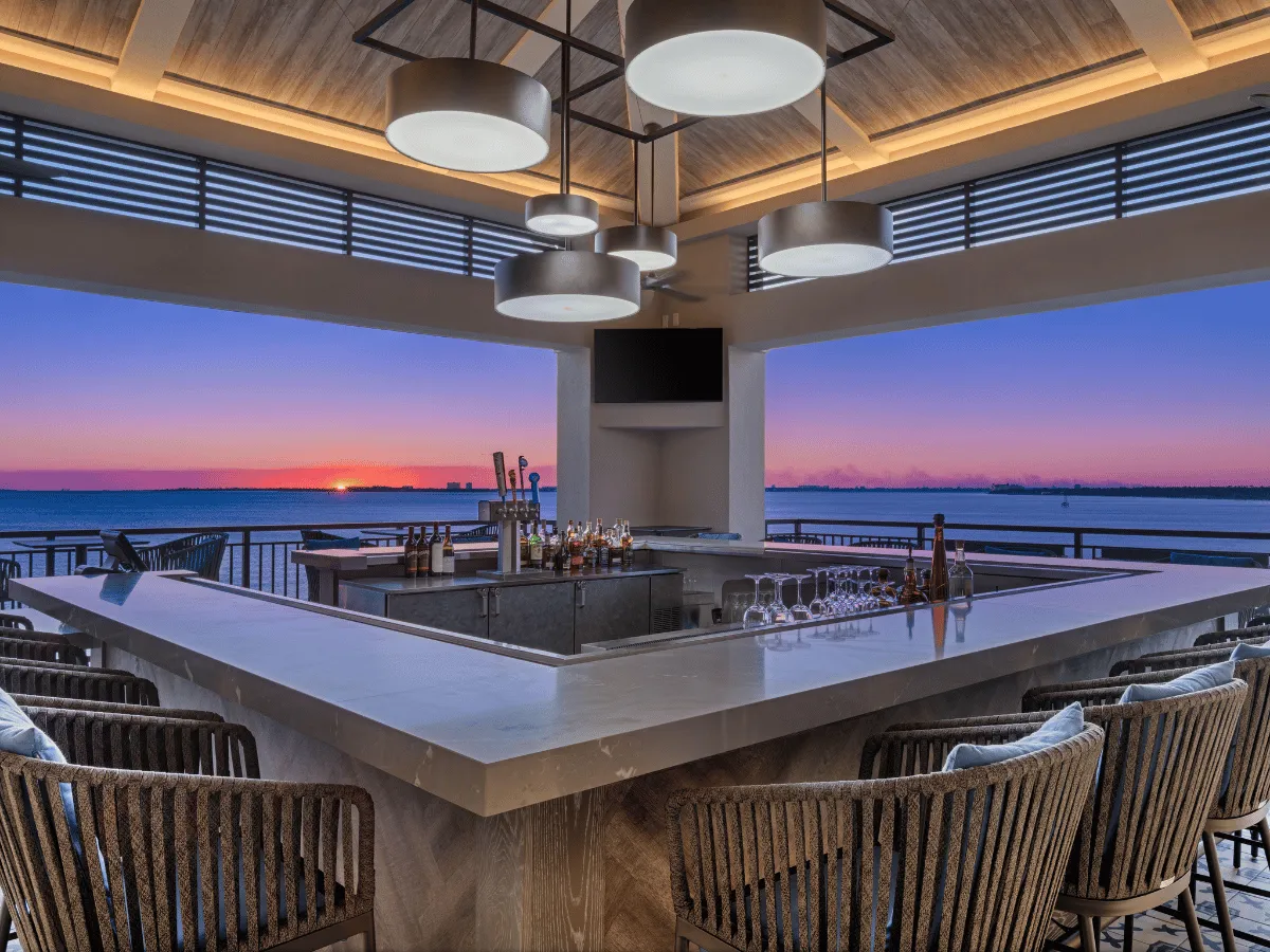 Rooftop bar overlooking a colorful sunset in Panama City Florida at Hotel Indigo Marina.